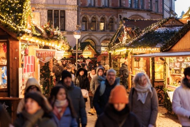 Visitors browse stalls at Hanover Christmas market.