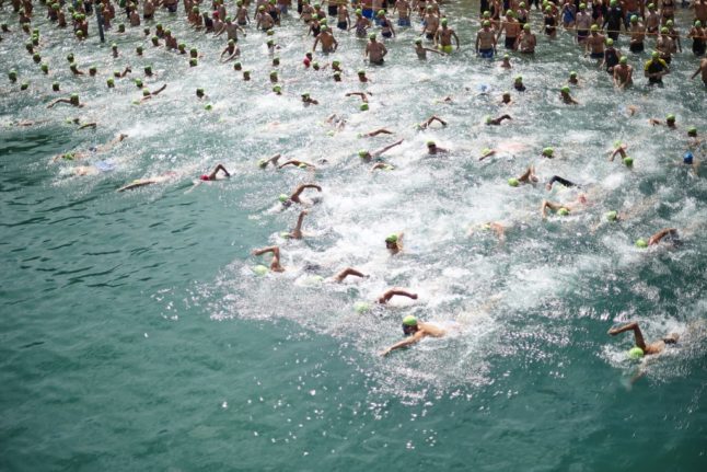 Swimmers leave the start of the annual Lake Zurich crossing swimming event in Zurich on July 5th, 2017.