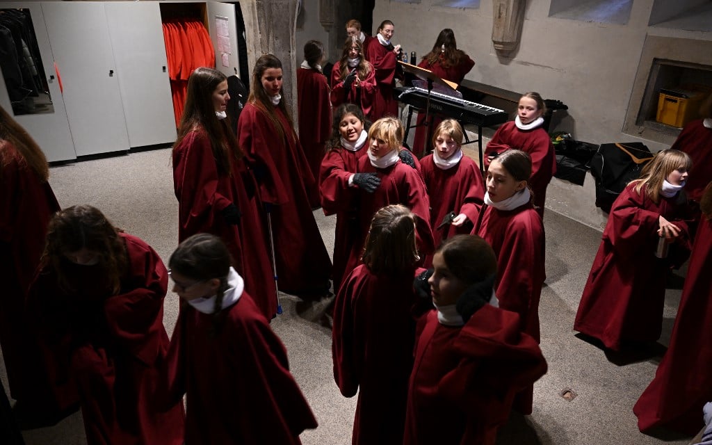 Members of the Regensburger Domspatzen girls' choir prepare for their first appearance during a service at the Regensburg Cathedral 