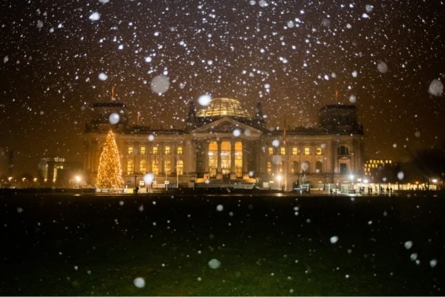 Snow falls outside the Reichstag in Berlin