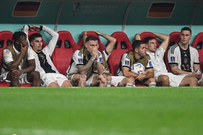 Germany's players (from left) Armel Bella-Kotchap, Kai Havertz, David Raum, Christian Günter, Leon Goretzka and Niklas Süle sit on the bench after the match against Costa Rica in Qatar.