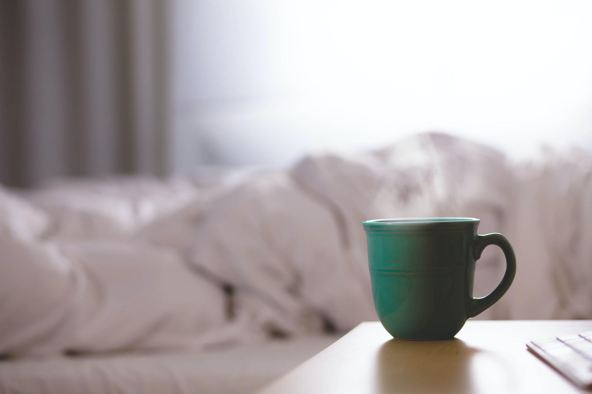 A cup of tea by a bed