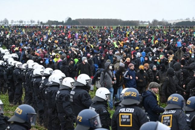Police face protesters during a large-scale protest to stop the demolition of the village Lützerath