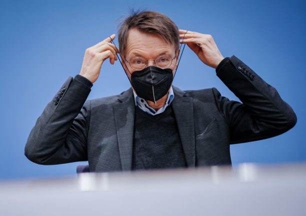 German Health Minister Karl Lauterbach wears a mask during a press conference in 2022.