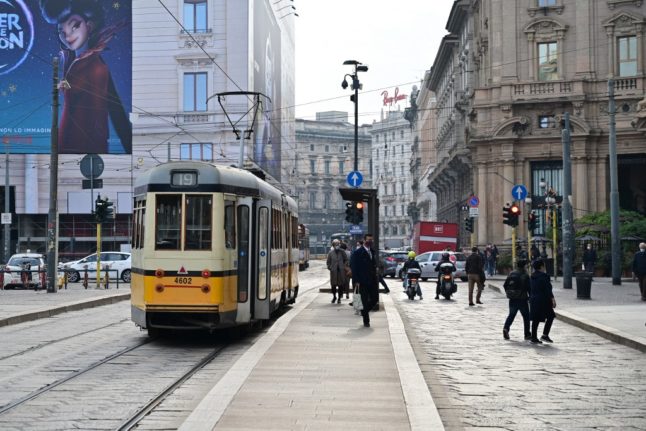 A tram heading down a street in Milan
