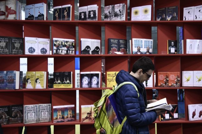 A visitor views a book on May 9, 2019 at the Turin International Book Fair in Turin.