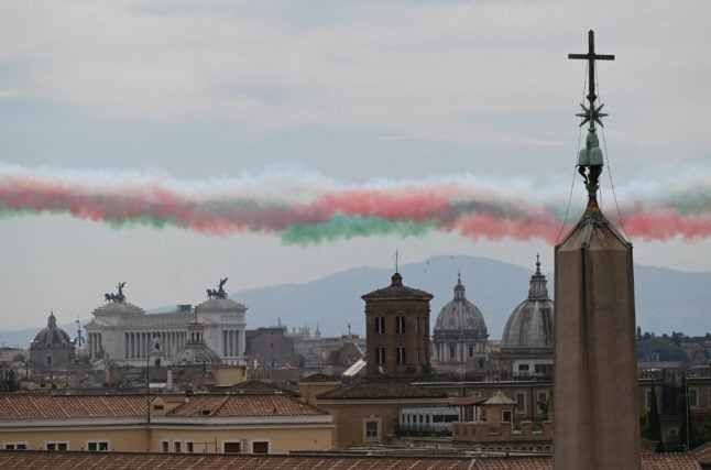 Italian flag coloured smoke is pictured in the sky after Italian Air Force aerobatic unit Frecce Tricolori (Tricolor Arrows) flown over Rome to mark Repubblic Day on June 2, 2021. 