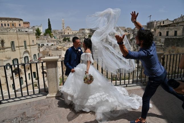 A just married couple poses for pictures in Matera, on June 29, 2021.