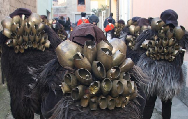 'Mamuthones' join other revellers in Mamoiada's carnival celebrations. Photo by MARIO LAPORTA / AFP.