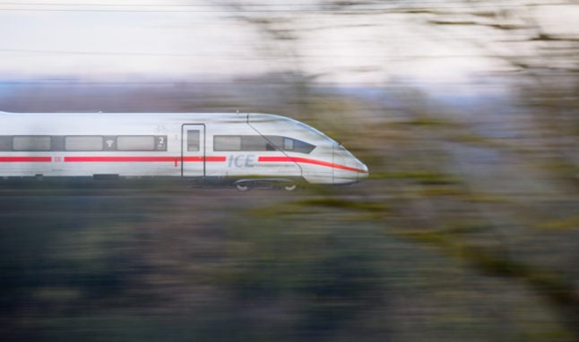 A Deutsche Bahn ICE train travels along a railway line in the Hanover region.