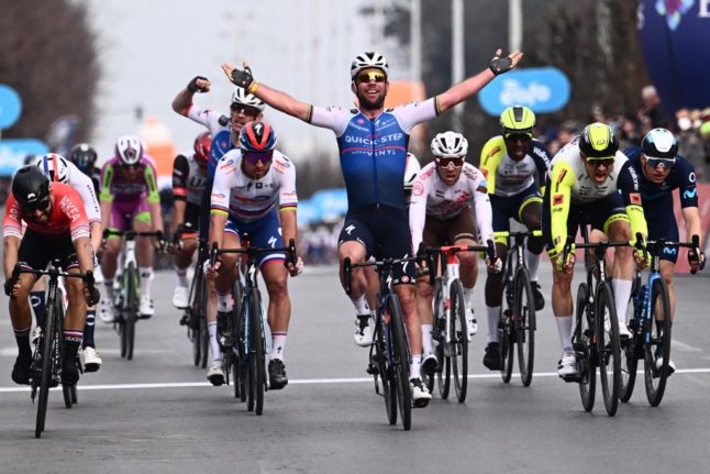 Britain's Mark Cavendish celebrates as he crosses the finish line on March 16, 2022 to win the Milan-Turin semi classic single day cycling race. 