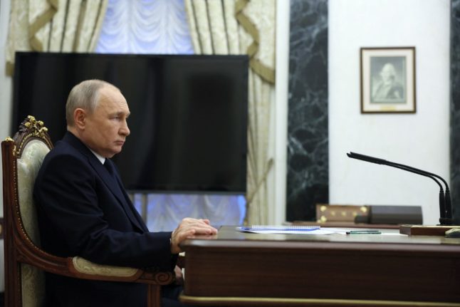 Russian President Vladimir Putin attends a meeting with Transport Minister at the Kremlin