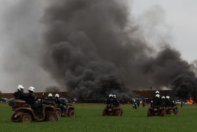 Mobile riot police riding quad bikes fire teargas shells towards protesters during a demonstration to protest against the construction of huge water reserves for agricultural irrigation in Sainte-Soline