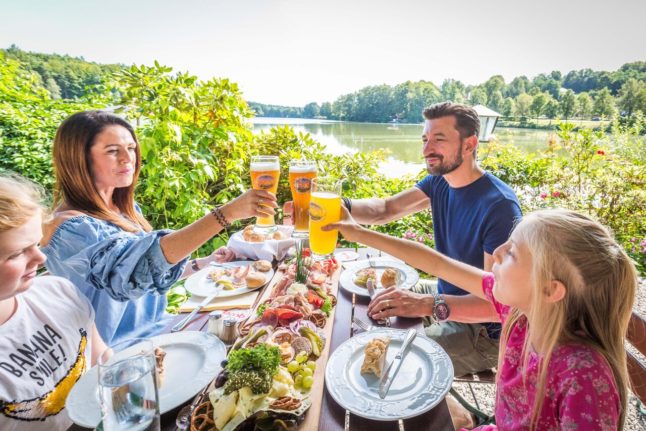 A family have dinner at a beer garden in the Upper Palatine Forest in Bavaria.