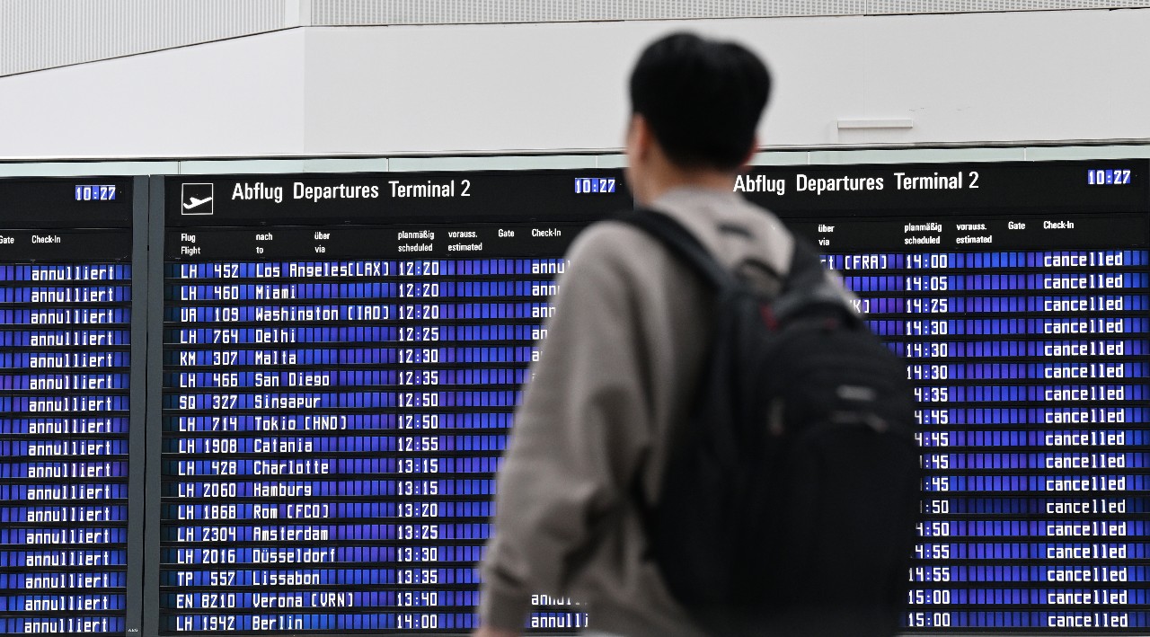 A passenger checks the departures board at Munich Airport on Monday