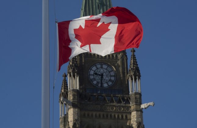 The Canadian flag flies at Peace Tower in Ottawa, Canada.