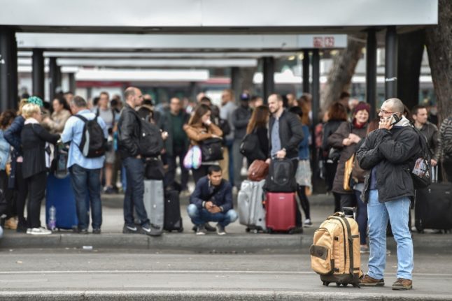 People waiting for a bus during a strike in Italy