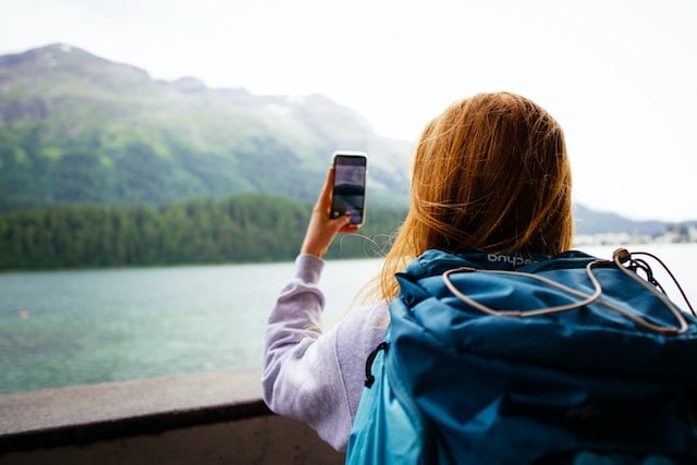 A young person taking photos in Switzerland.