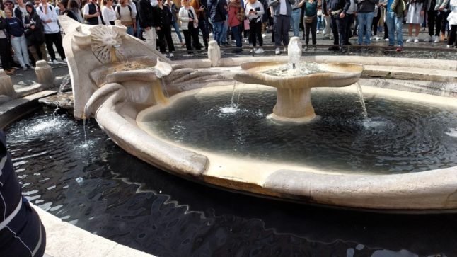 Climate activists turned the fountain below Rome's Spanish Steps black