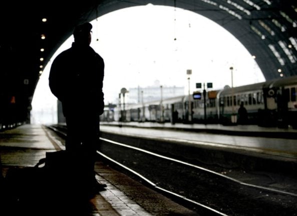Man awaiting train at Milan railway station