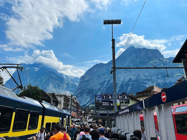 Lots of people stand at the station in Grindelwald, Switzerland, in January 2023.