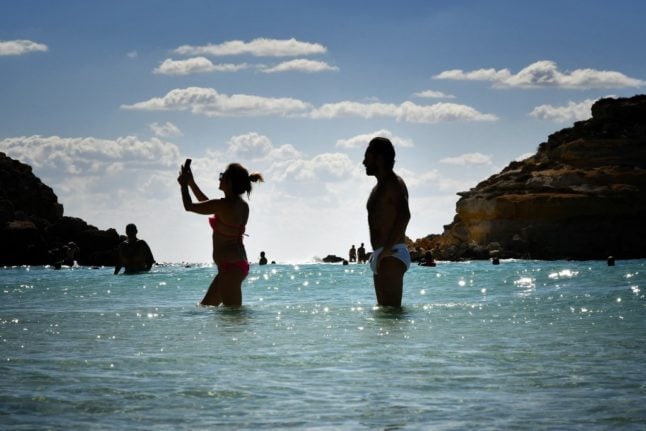 Tourists on the Isola dei Conigli (Rabbit Island) beach in Lampedusa. 