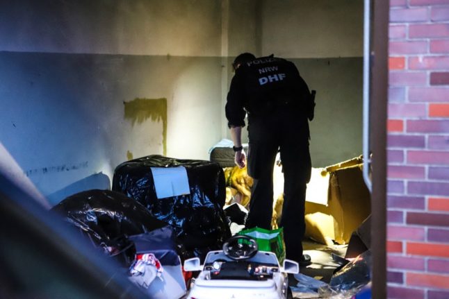 A police officer conducts an anti-mafia raid on a garage in Hagen, western Germany, on May 3, 2023.
