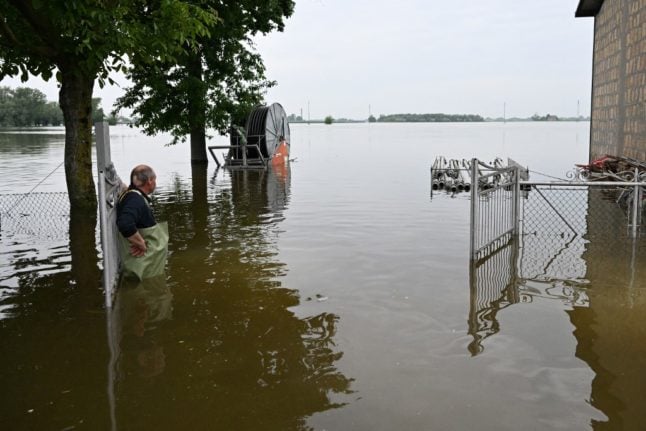 A fruit farmer considers his flooded property on May 20, 2023 in the village of Ghibullo, near Ravenna.