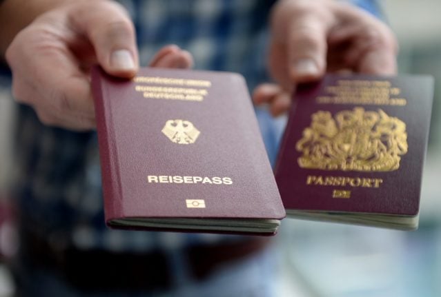 A man presents a German and a British passport