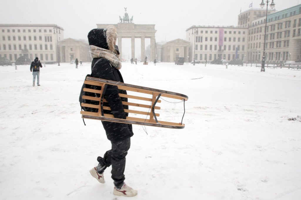 A tourist walks across Pariser Platz at the Brandenburg Gate in temperatures around minus 10 C in Berlin in February, 2021.