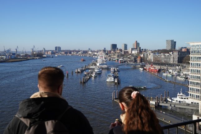 Young people look at the view from Hamburg's Elbphilharmonie.