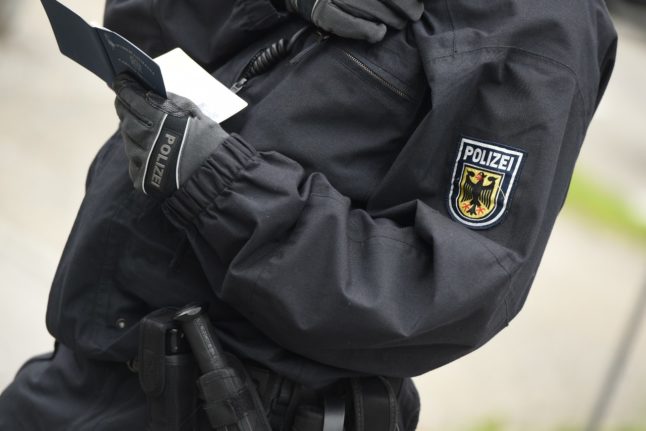 A police officer checks an individual's ID near Bodensee