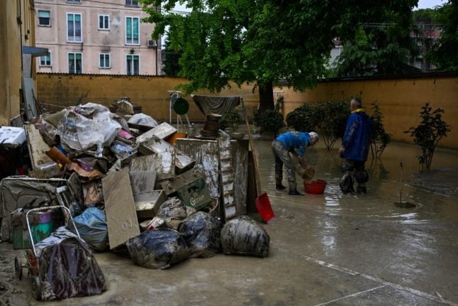 Emilia Romagna residents clearing their flooded houses