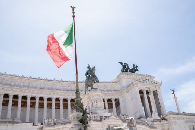 Italian flag in front of monument in Rome