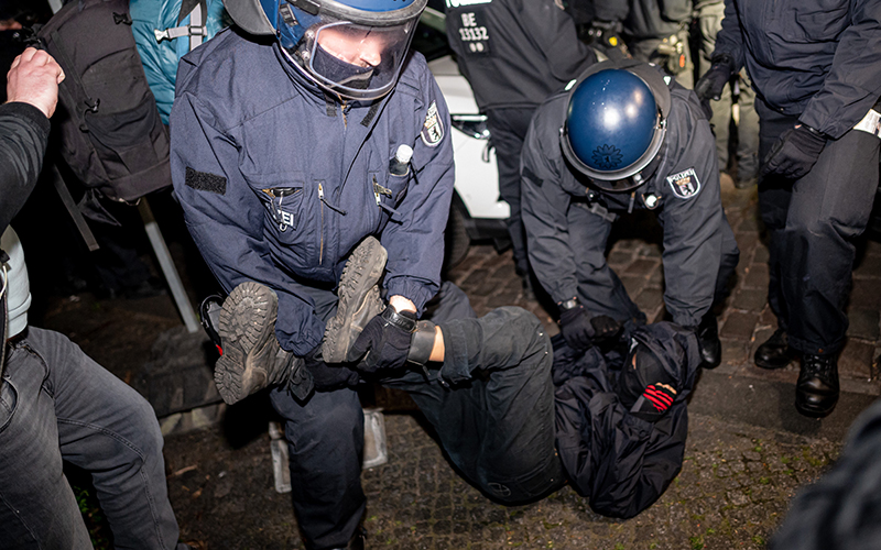 police deal with a masked protester at a take back the night demonstration in berlin