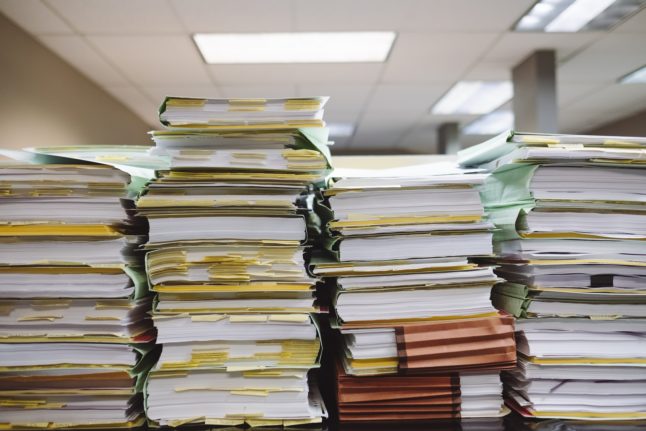 Pictured is a stack of paperwork.