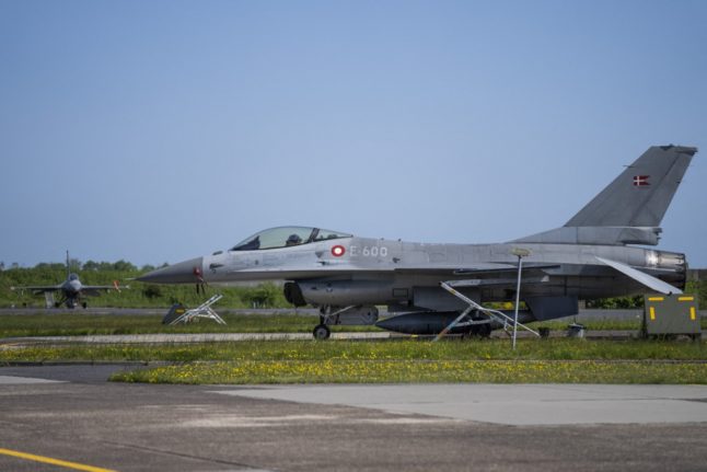 Pictured is an F-16 fighter jet on a runway.
