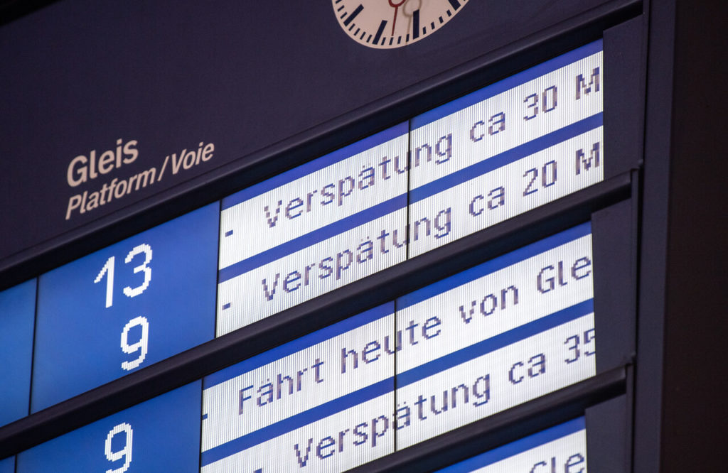 A display board at Stuttgart's main station shows delays for several train connections.