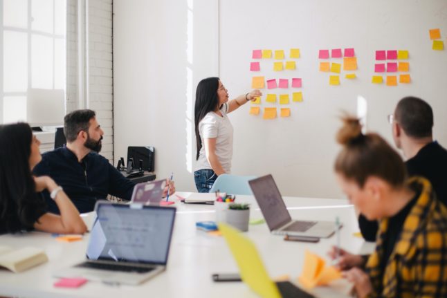 Pictured is a team during a brain storming session at work.