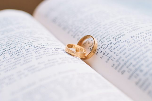 Two wedding rings on book page