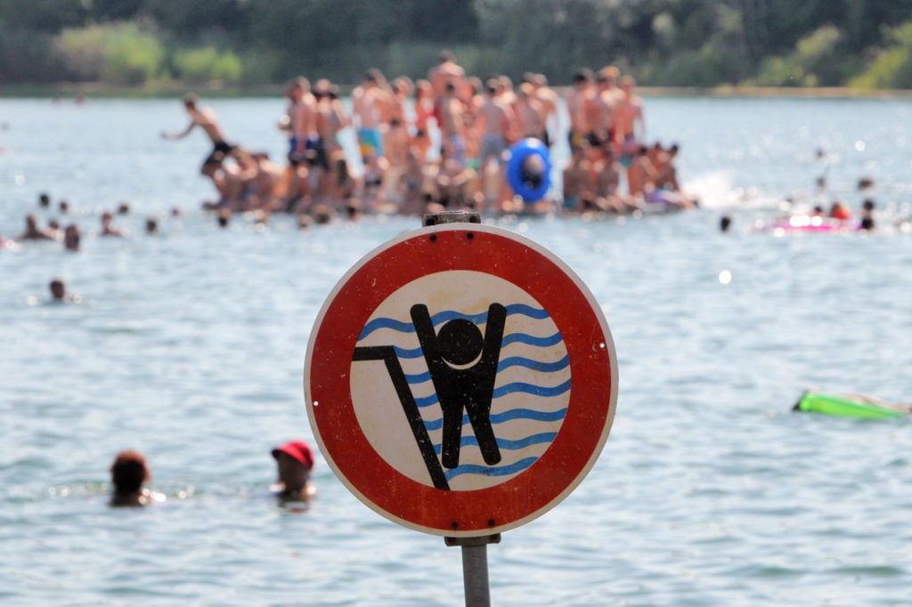 A sign at a lake in Bensheim, Hesse, warns swimmers about a steeply sloping bank