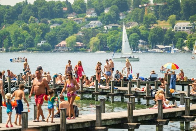 People enjoy summer sun at the Starnberger See in Percha, Bavaria.