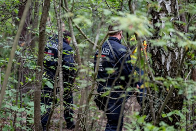 Police officers search through undergrowth near the southern border of Berlin on Friday, July 21st.