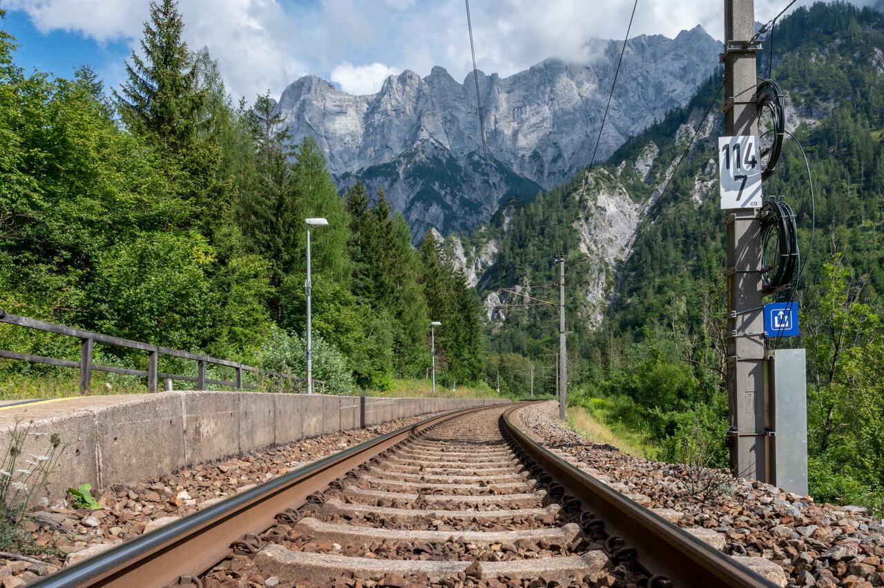 A train line leads towards the Austrian Alps.
