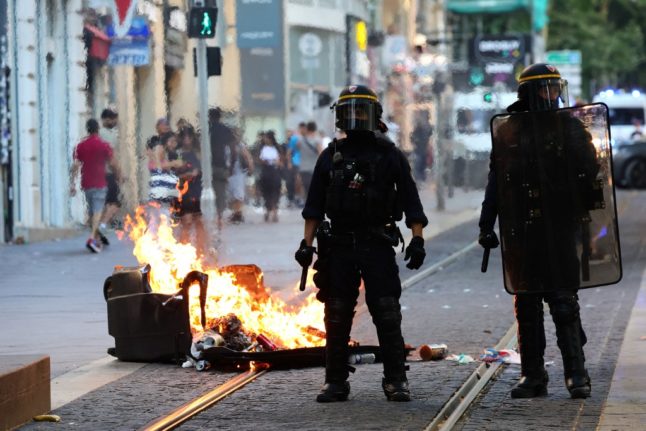 Three French police charged over man's death during riots