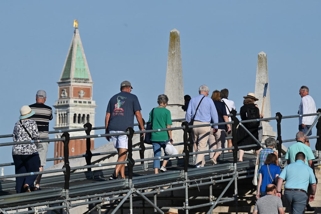 A view taken on July 31, 2023 shows tourists walking towards St. Mark's square in Venice.