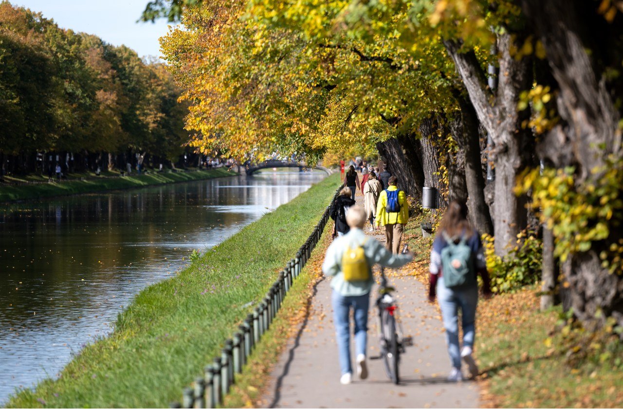 People walk along the Nymphenburg canal in Munich.