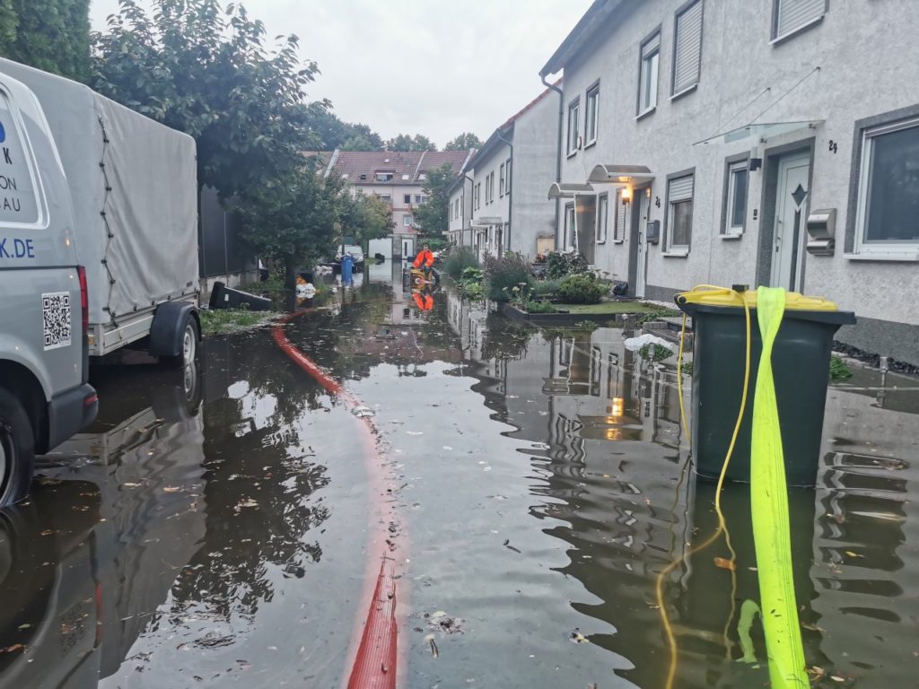 Emergency services pump water out of a flooded street in Essen.