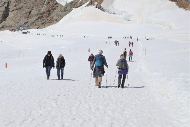 People walk in the Swiss Alps