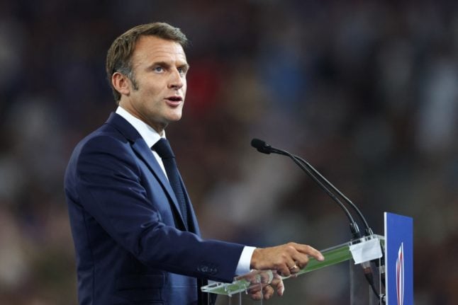 France's President Emmanuel Macron addresses the crowd ahead of the opening Rugby World Cup match between France and New Zealand at the Stade de France